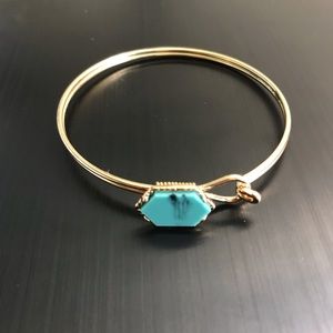 Gold bangle with turquoise gemstone